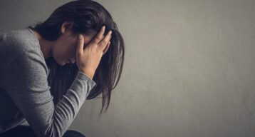 Girl with head in hands